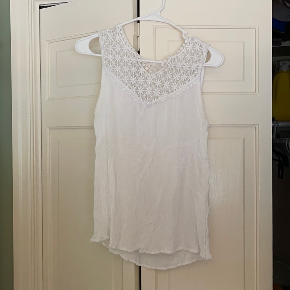 Lace white blouse with detail at top.